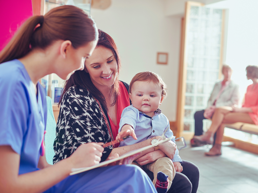 Nurse with patient and her baby