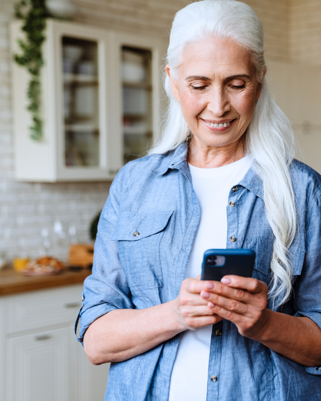 older white haired female using smartphone