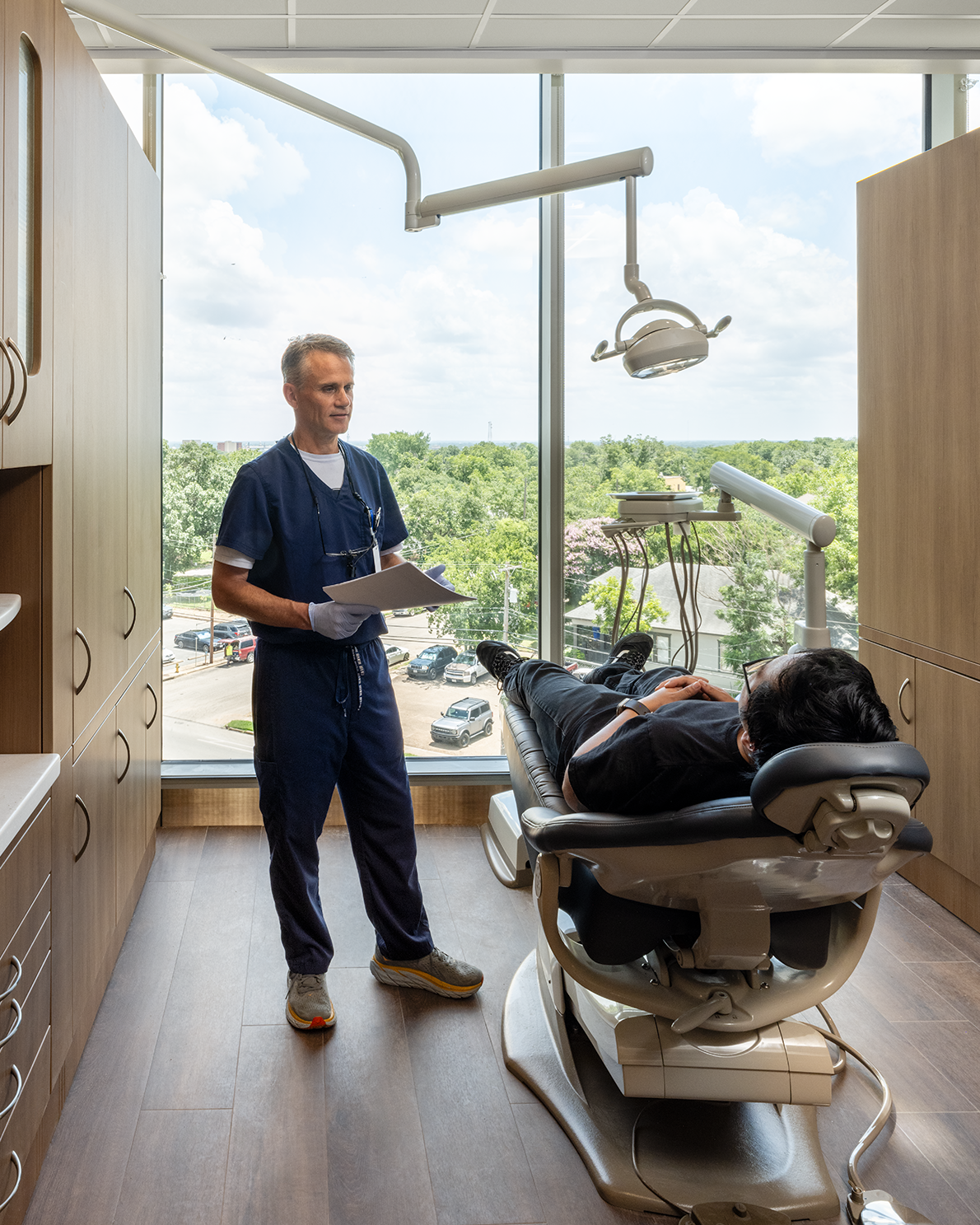 dentist with patient in dental chair at new Central facility