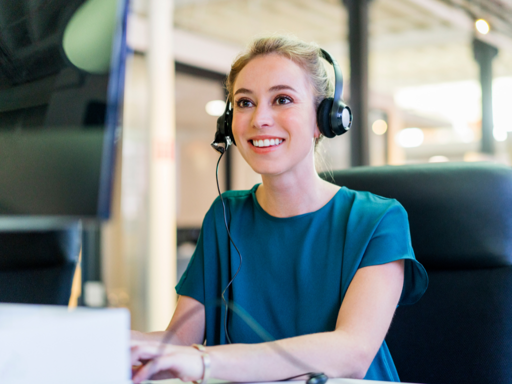 female billing representative on computer with headset