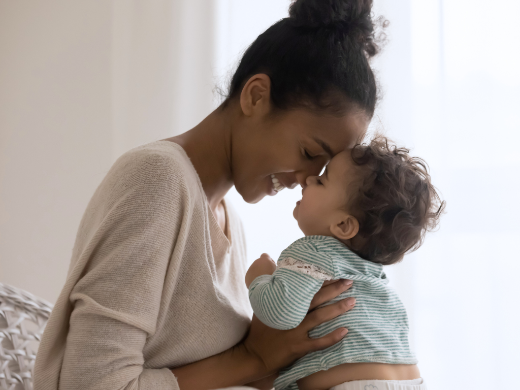 Woman smiling and loving her baby