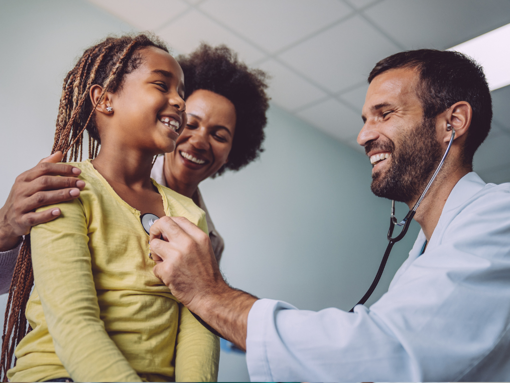 Clinician checking heartbeat of black female child