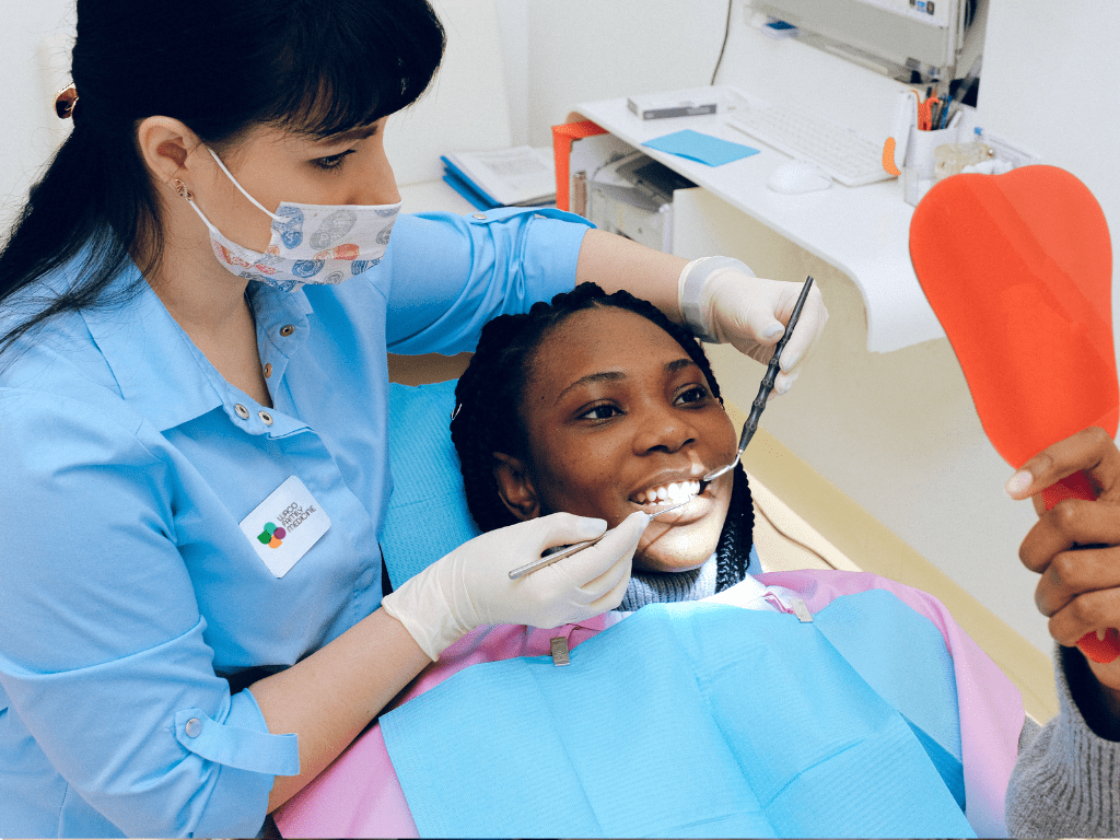Female dentist with a black female patient