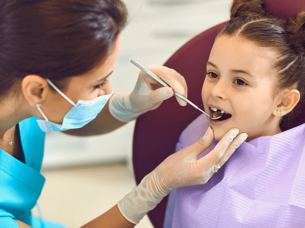 Female dentist with a female child patient